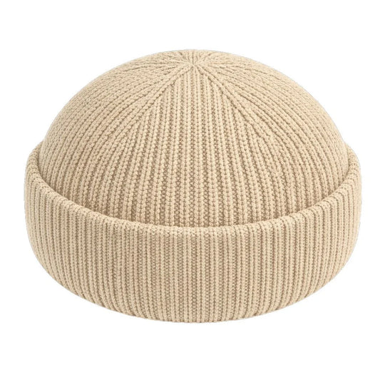 Best minimalist fisherman beanie. Beige knit beanie on a white background