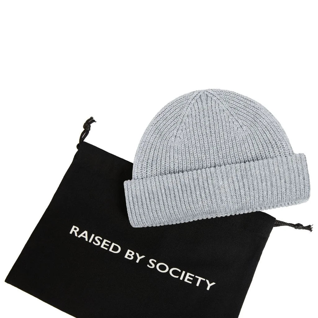 Modern fisherman beanie style. Black gifting dust bag with light grey beanie.