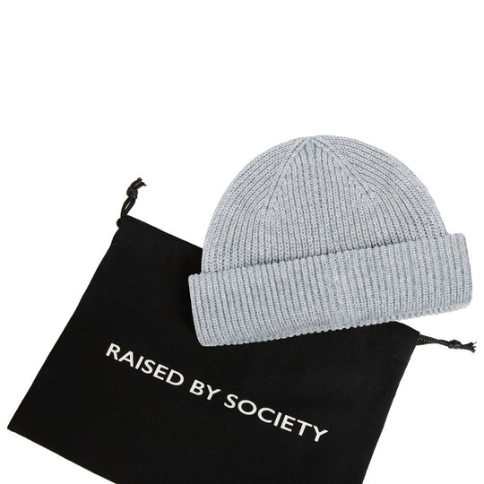 Modern fisherman beanie style. Black gifting dust bag with light grey beanie.
