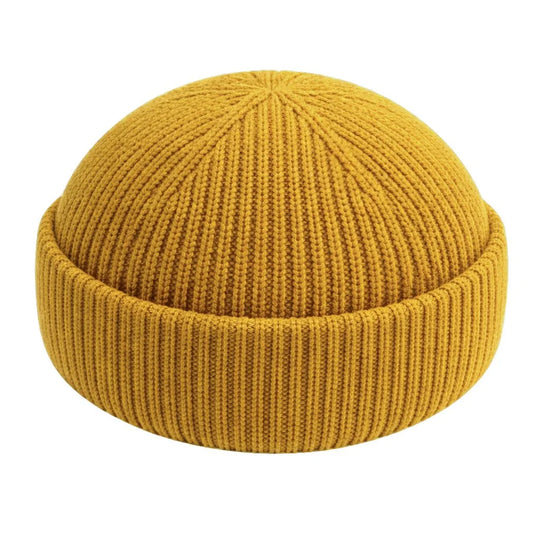 Street style fisherman beanie cotton. Yellow knit beanie on a white background.