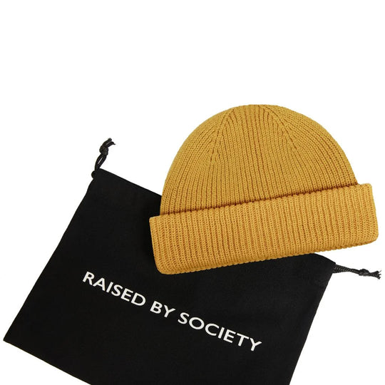 Classic fisherman beanie cotton. Mustard yellow with black carry bag. RAISED BY SOCIETY logo on the bag. Perfect for gifting. 