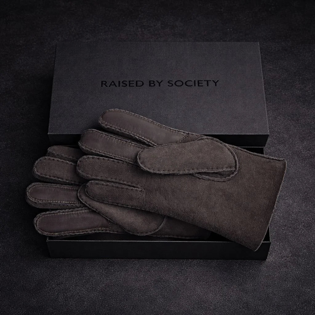 Premium suede gloves gift for winter. Box included placed on a concrete background. 